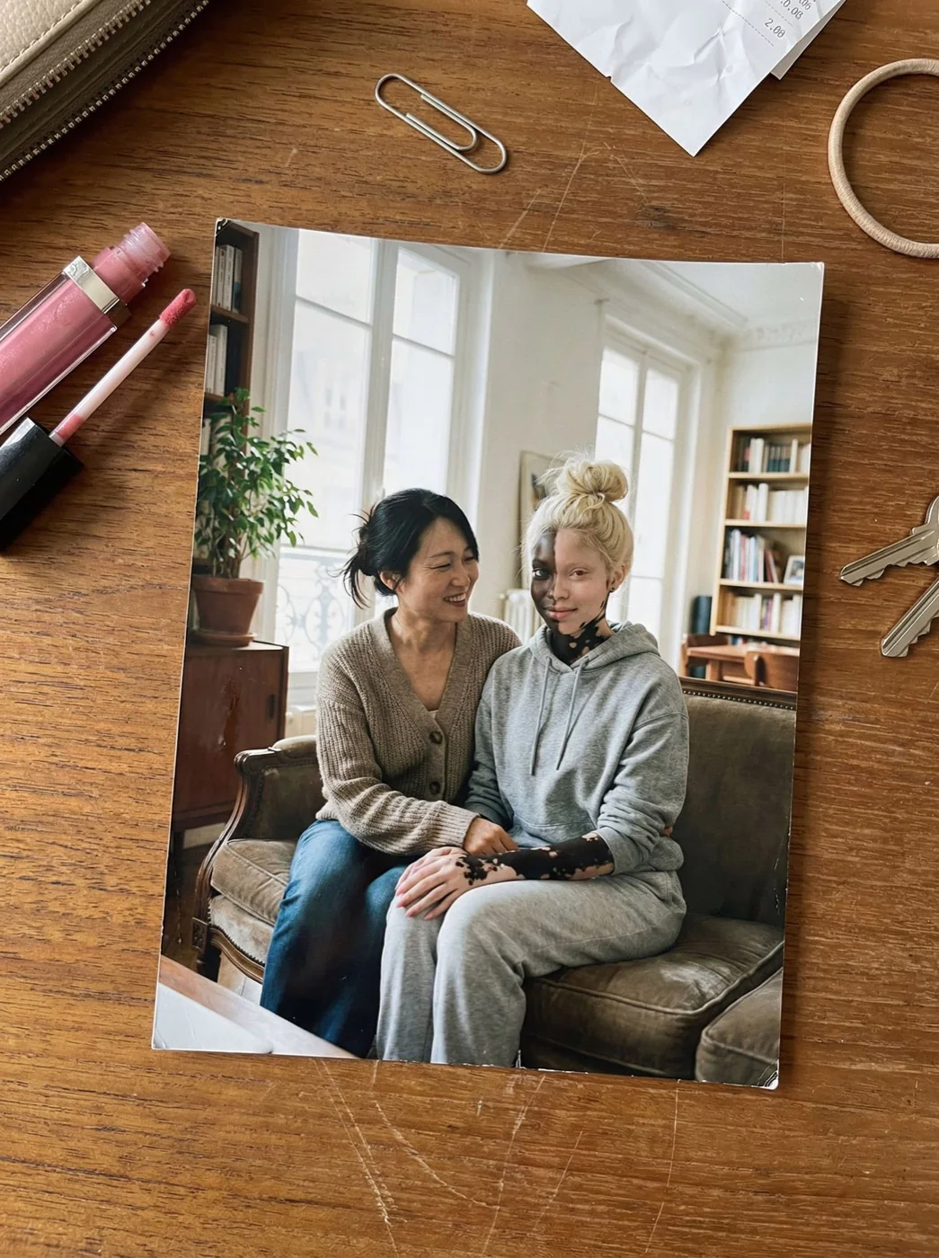 Eva sitting beside her mother, both smiling